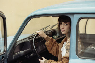 Portrait of woman sitting in car