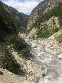 Scenic view of river flowing through rocks