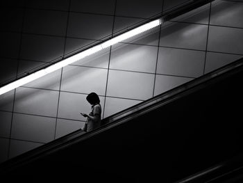 Low angle view of woman walking on staircase