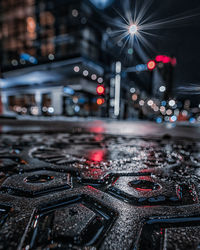 High angle view of illuminated city at night, ground level depth of field.