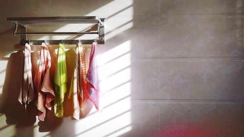 Close-up of clothes drying against wall at home