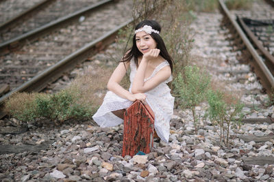 Young woman standing on railroad track