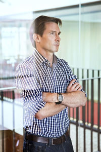 Handsome mature man standing with arms crossed