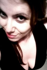 Close-up portrait of beautiful woman against black background