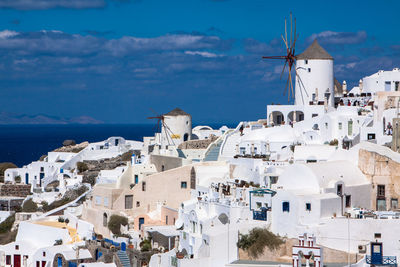 High angle view of town against blue sky