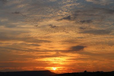 Scenic view of dramatic sky during sunset