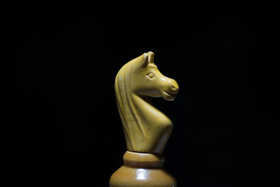 Close-up of statue against black background