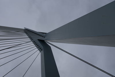 Low angle view of suspension bridge against sky