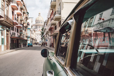 Cars on street amidst buildings in city