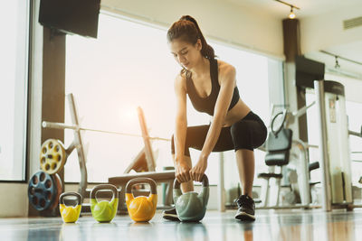 Full length of woman exercising in gym