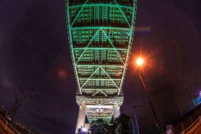 Low angle view of illuminated bridge against sky at night