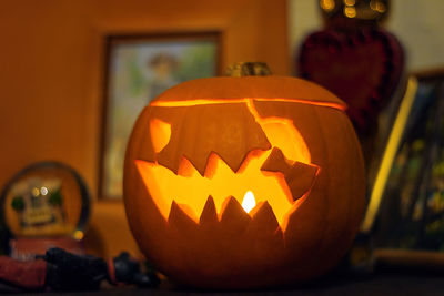 Halloween pumpkin carved lantern. scary pumpkin face with a burning candle inside