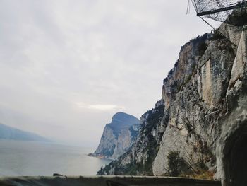 Scenic view of sea and mountains against sky