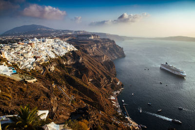 High angle view of sea and mountains against sky