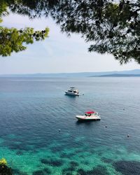 Boat sailing in sea against sky