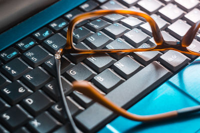 Close-up of eyeglasses on computer keyboard