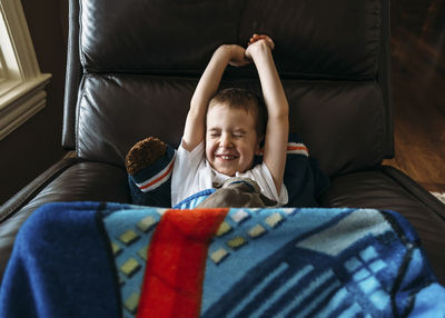 Boy waking up in armchair