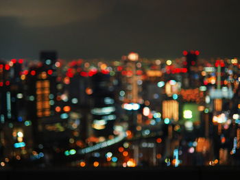 Defocused image of illuminated city at night