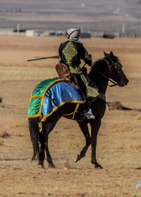 Horse riding on sand