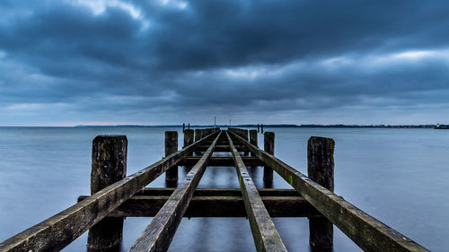 Pier over sea against sky