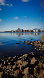 Scenic view of lake against blue sky