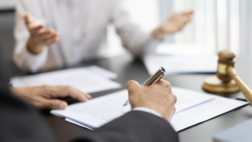 Midsection of business colleagues working in office