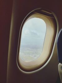 Cloudy sky seen through airplane window