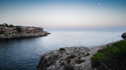 Scenic view of sea against clear sky during sunset