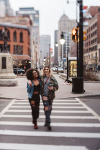 Woman crossing road in city