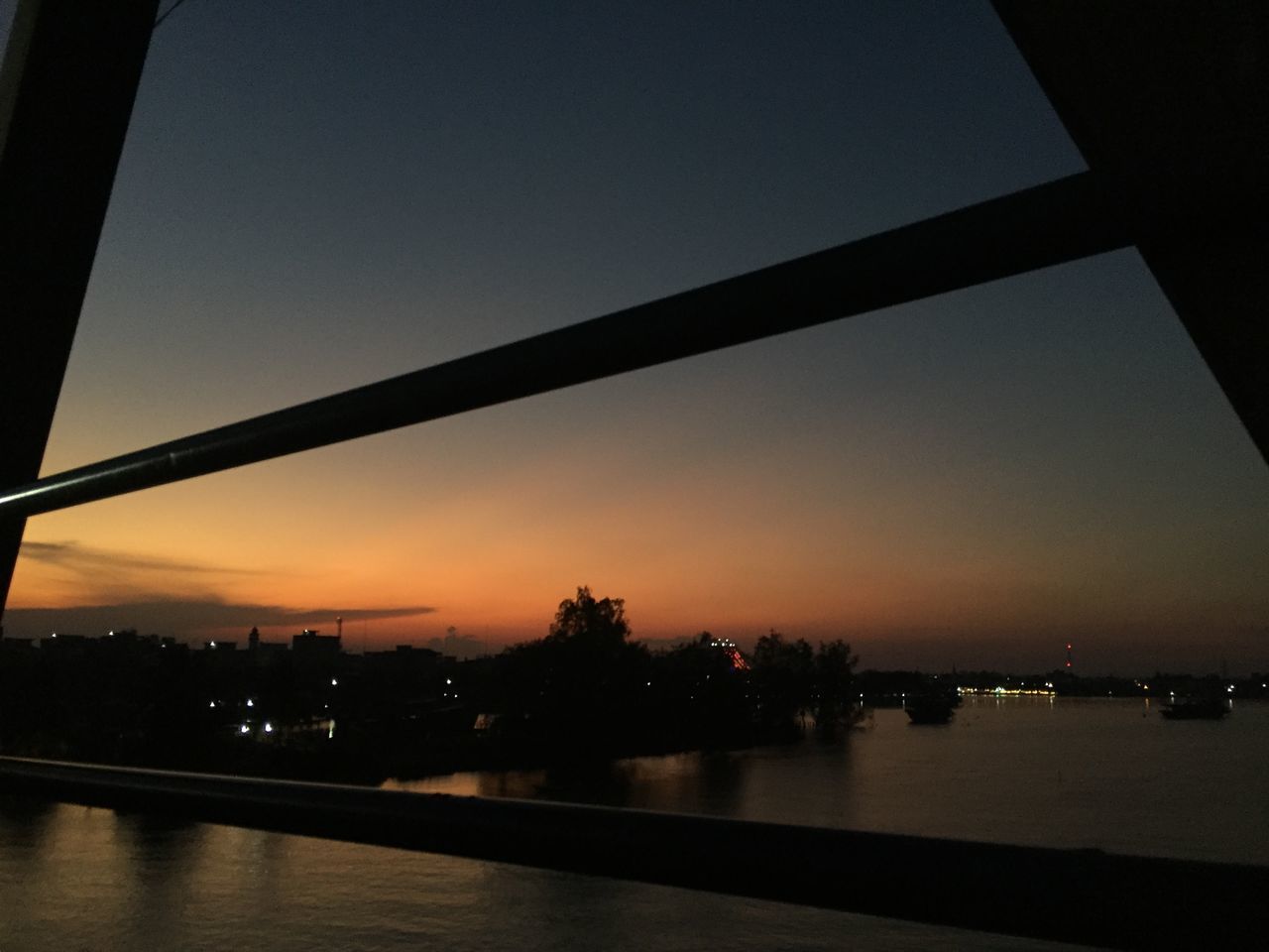 ILLUMINATED CITYSCAPE AGAINST SKY AT SUNSET