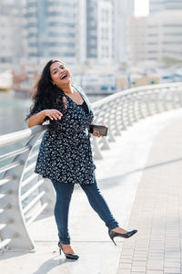 Portrait of a laughing indian woman while walking around the city. positive emotions, cheerful girl.