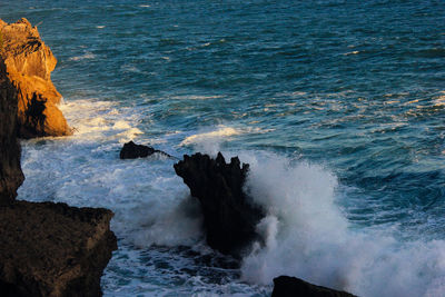 Scenic view of rocks at sea