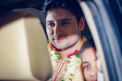 Close-up of thoughtful bridegroom sitting in car