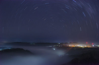 Light trails against sky at night