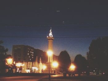 Low angle view of illuminated street light against sky