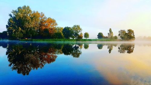 Reflection of trees in lake against sky