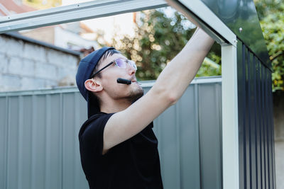 Young woman looking through window