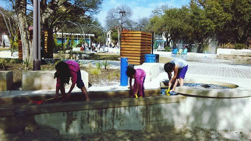 Woman standing on tree trunk