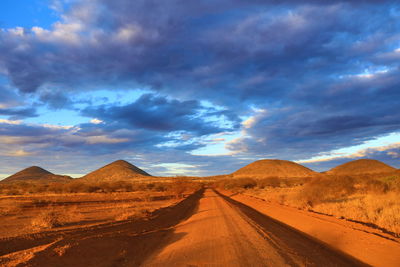 Scenic view of mountains against cloudy sky