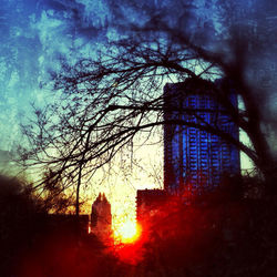 Low angle view of buildings against sky at sunset