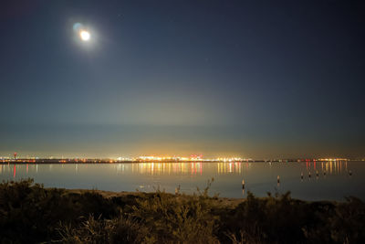 Scenic view of lake against sky at night