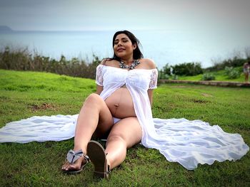 Portrait of woman sitting on field