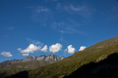 Scenic view of mountains against blue sky