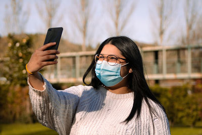 Portrait of young woman using mobile phone