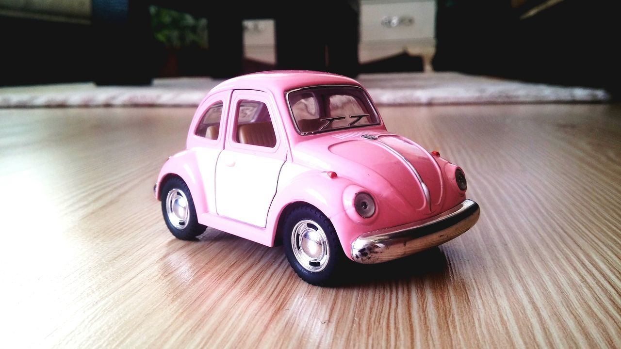 car, transportation, land vehicle, pink color, focus on foreground, toy car, vehicle, no people