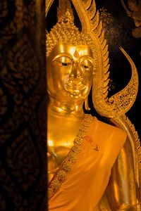 Close-up of buddha statue against building