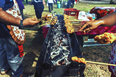 Low section of people on barbecue grill