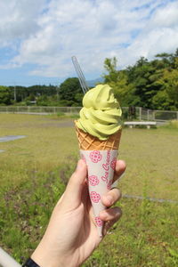 Close-up of hand holding ice cream cone