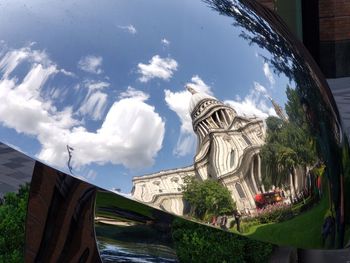 Panoramic view of sculpture by building against sky