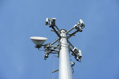 Low angle view of floodlight against clear blue sky